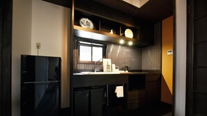 A kitchen with a refrigerator, sink, and a window. - Shibashi Umeyacho (Kyoto)