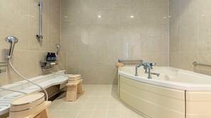 A modern bathroom with a bathtub, shower, and wooden stools. - Glamday Port Sea-view Hill (Atami)