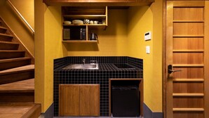 A compact kitchen with a sink, microwave, and storage cabinets. - Tsumugi Horikawa Kichimonji (Kyoto)