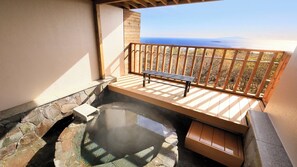 A hot spring area with a wooden bench and stone steps.