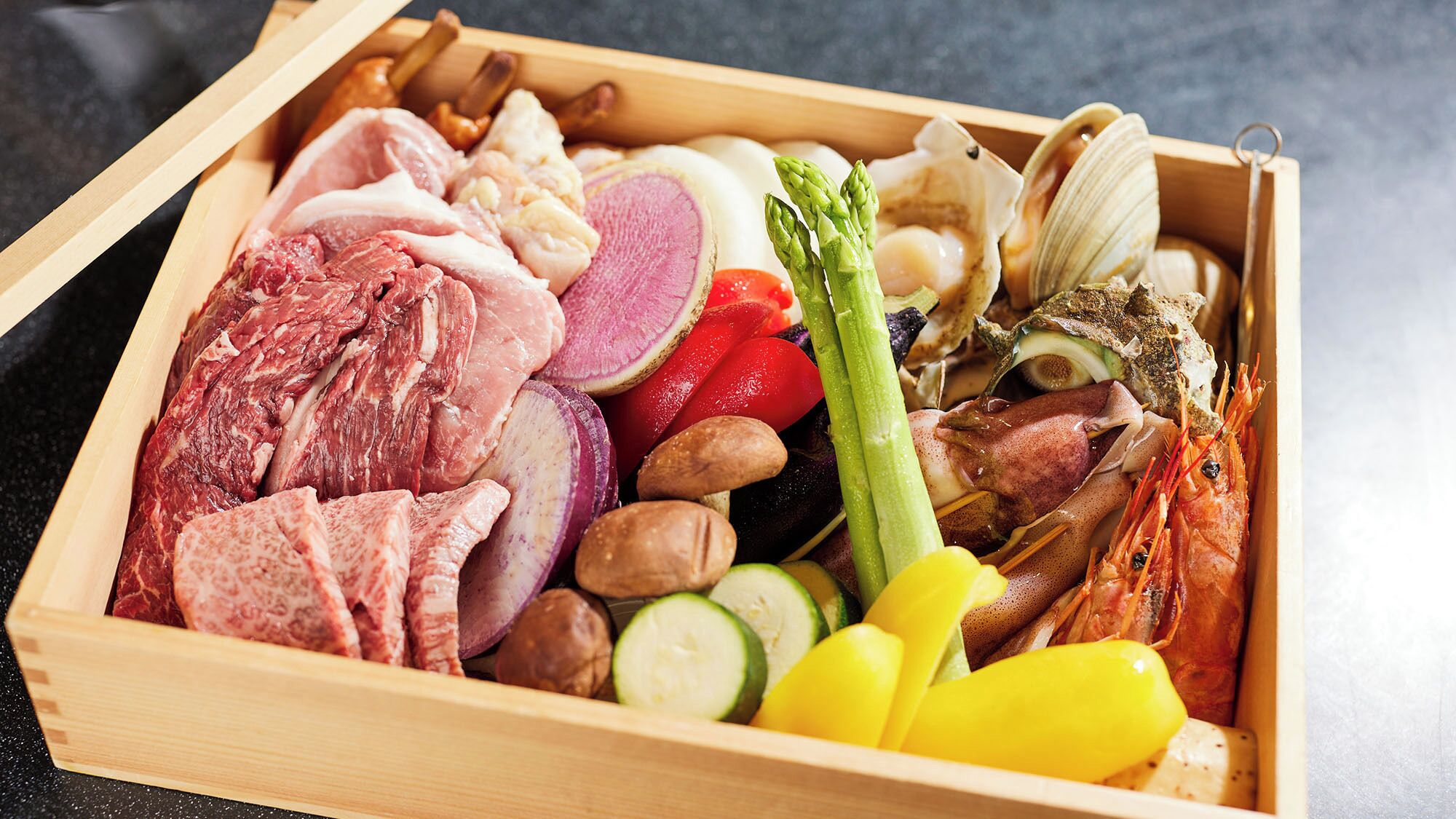 A wooden box containing various food items including meats, vegetables, and seafood.