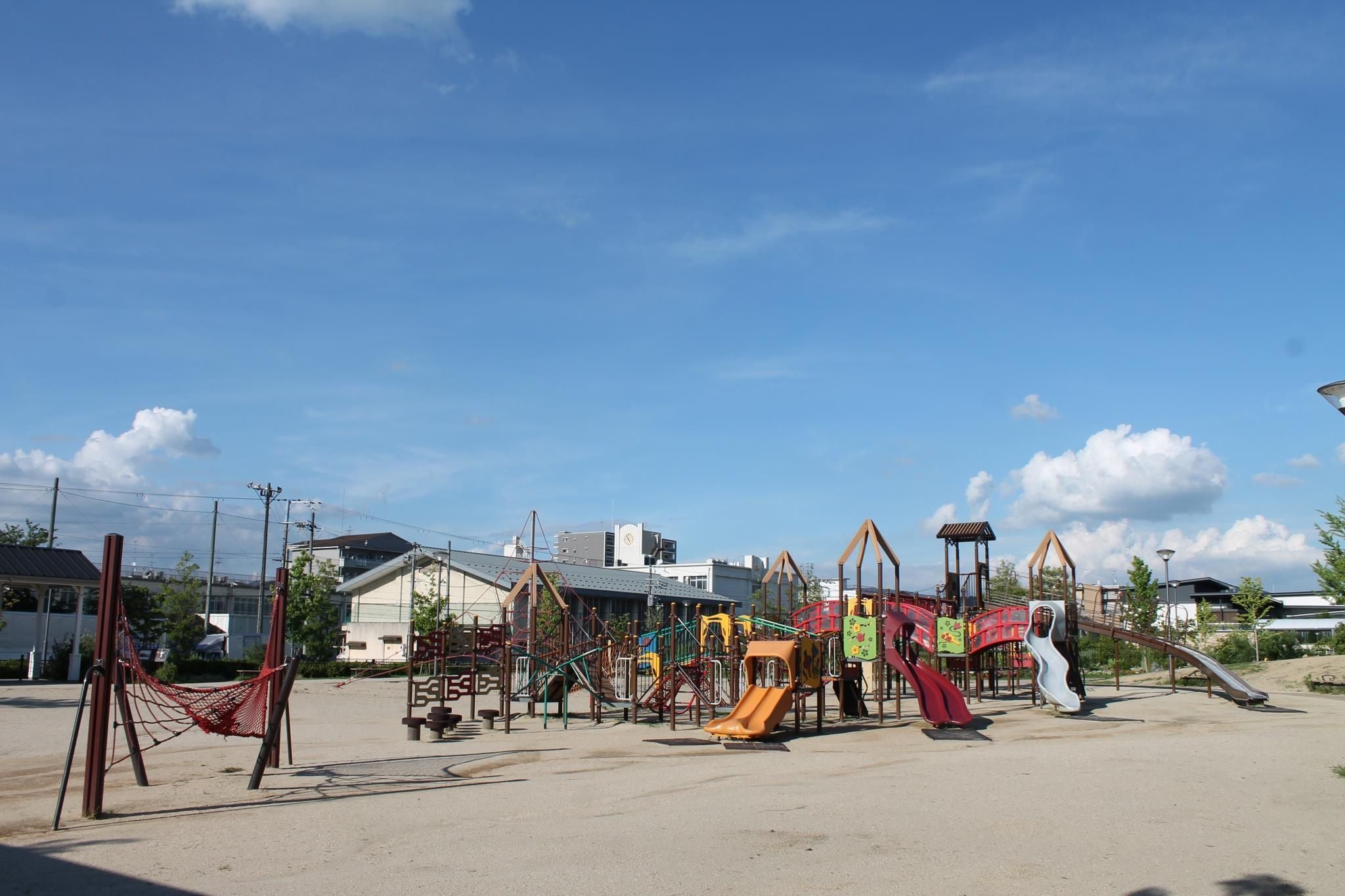 A playground with various play structures including slides and climbing frames.