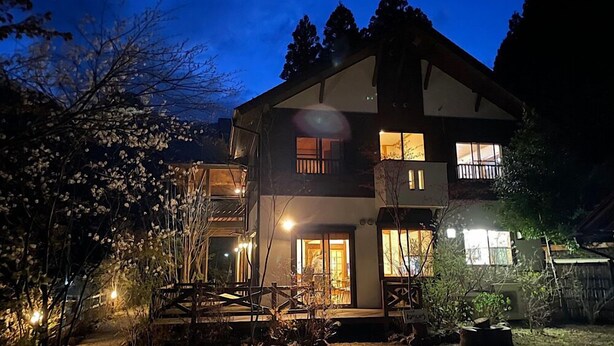 A two-story building with a balcony, a staircase, and a lit entrance. - Yasuragi no Yado Nenenbou (Okutama)