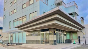 A hotel with a modern facade, large windows, and a prominent entrance.