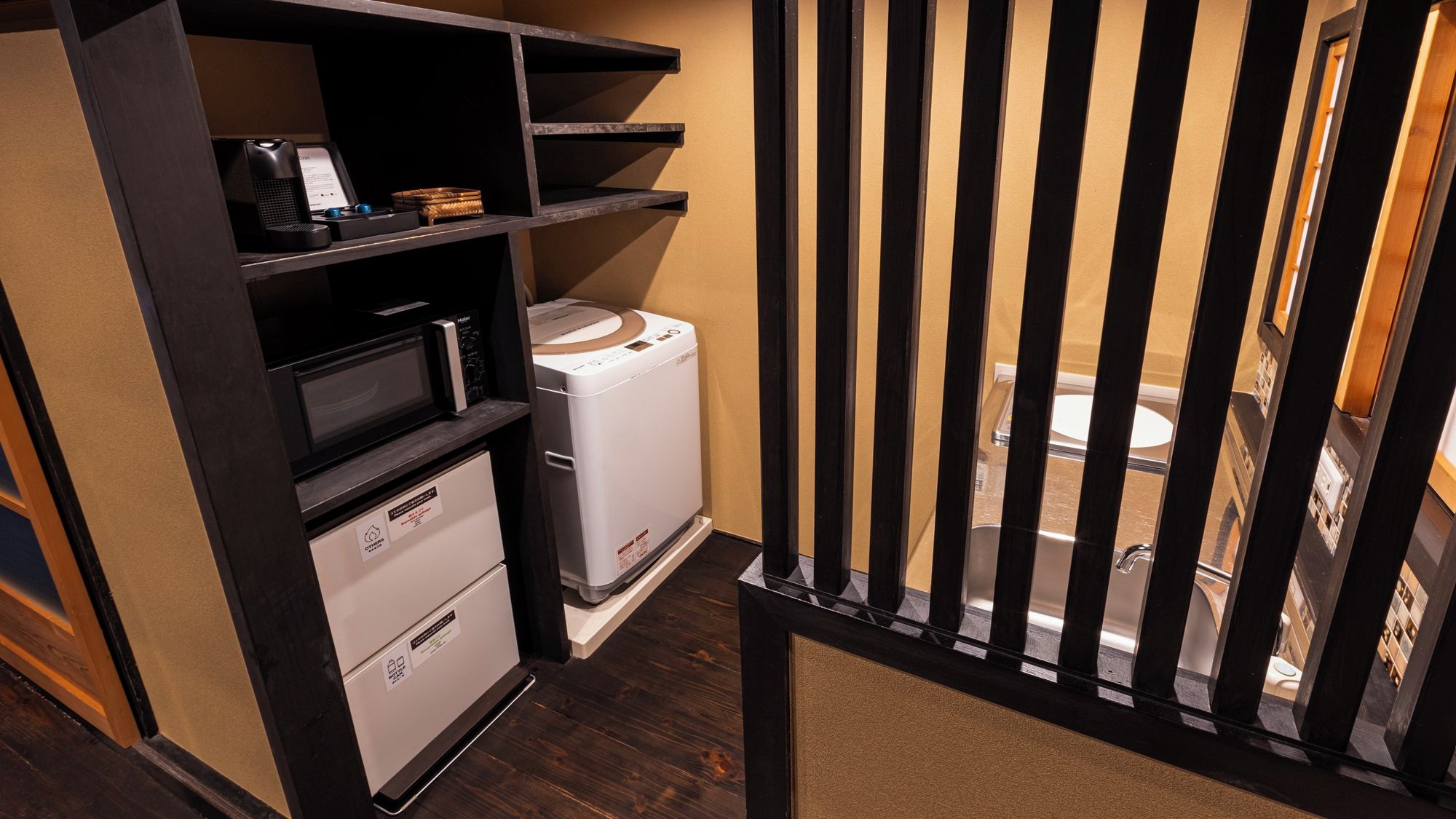 A compact kitchenette with a microwave, a small refrigerator, and a sink.