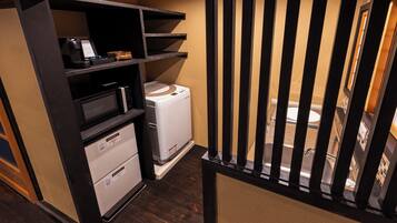 A compact kitchenette with a microwave, a small refrigerator, and a sink.