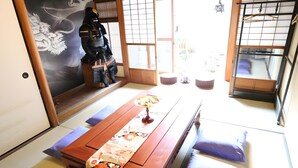 A traditional Japanese room with tatami flooring, a low wooden table, and a shoji screen door. - Satsukian (Kyoto)
