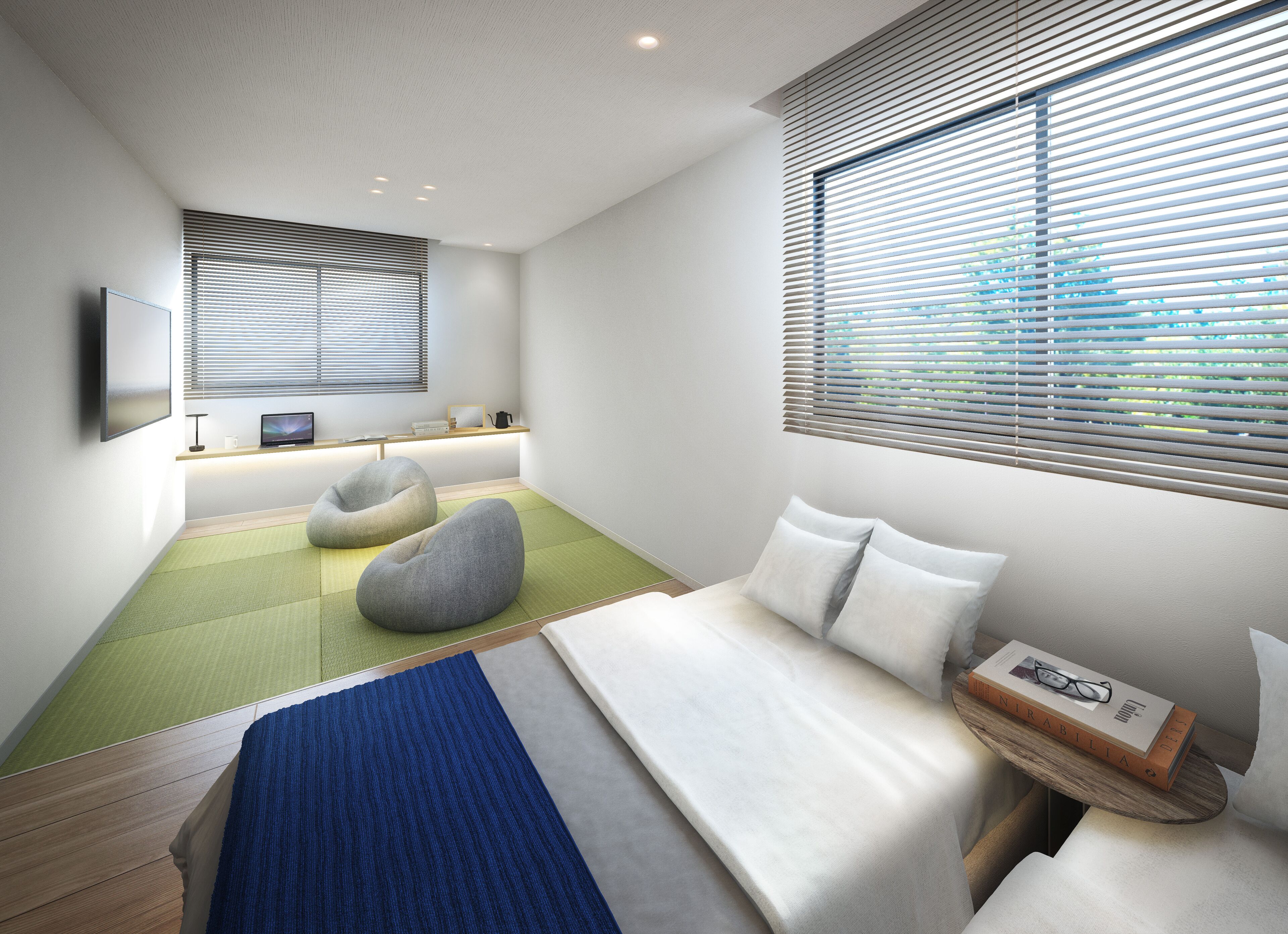 A modern bedroom with a bed, two bean bags, a desk with a computer, and a window with blinds.