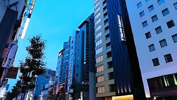 A modern hotel with multiple floors, large windows, and a prominent sign. - Business Hotel Urbanty Nishikujo (Osaka)