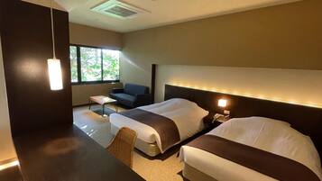 A modern hotel room with two beds, a sofa, a small table, and a large window.