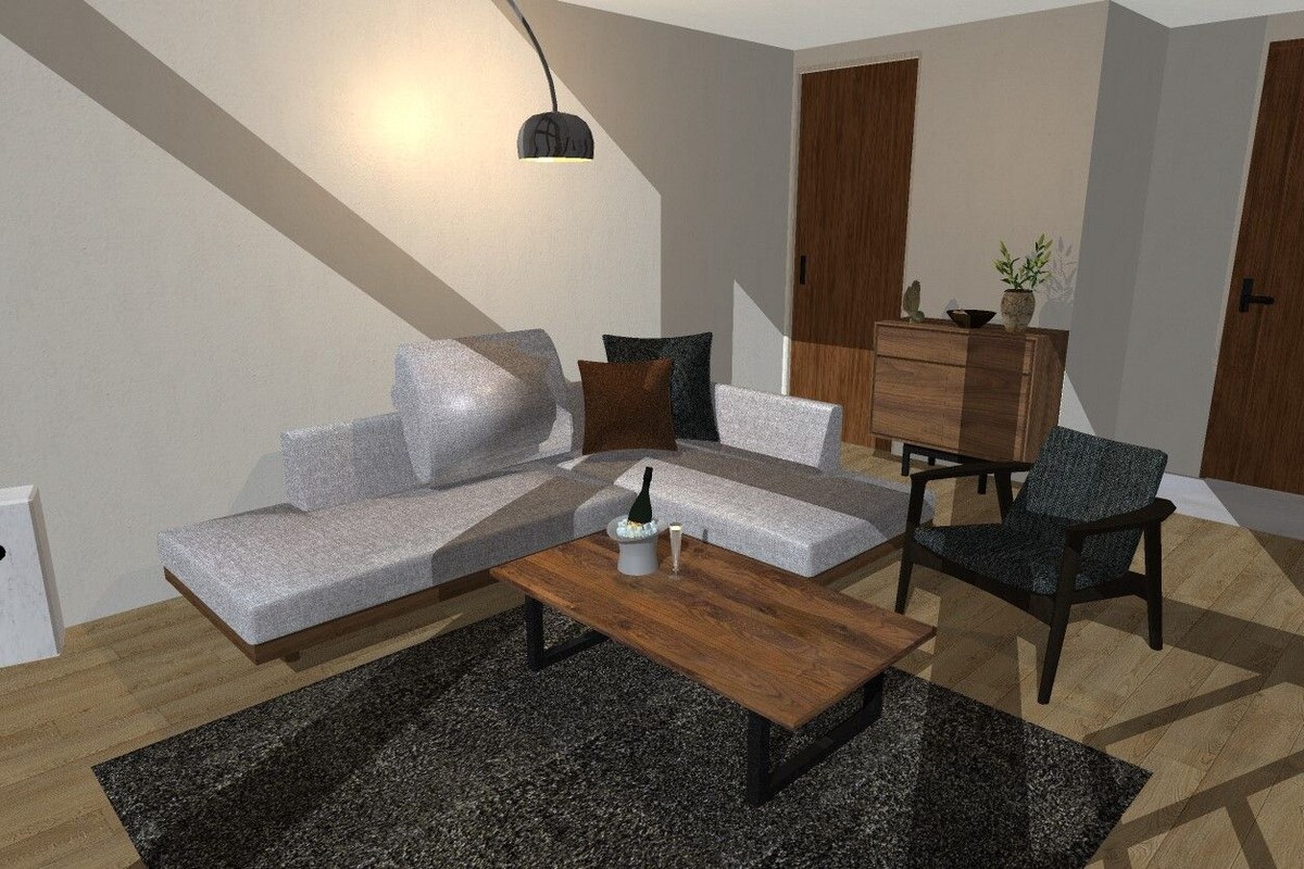 A modern living room with a sofa, coffee table, and armchair, a wooden cabinet, and a pendant light.