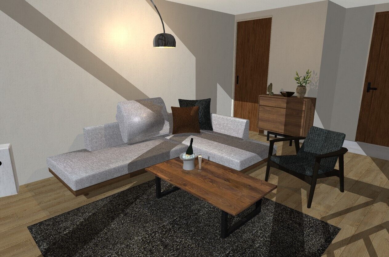 Una sala de estar moderna con sofá, mesa de centro y sillón, un aparador de madera y una lámpara colgante.