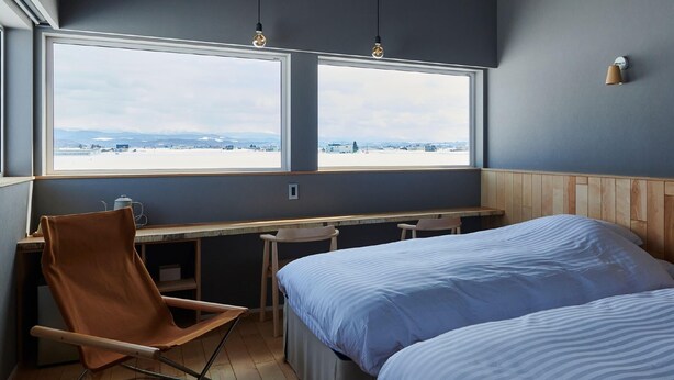 A room with a bed, a chair, a desk, and a window with a view. - Higashikawa Perican (Higashikawa)
