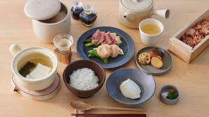 A traditional Japanese meal setup with a teapot, cups, bowls of rice, and various dishes. - Higashikawa Perican (Higashikawa)