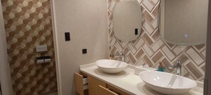 A bathroom with two sinks, a mirror, and a towel dispenser. - Yunni No Yu (Yuni)