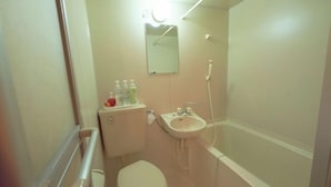 A small bathroom with a toilet, sink, and mirror. - Hotel 4F Macaroni (Osaka)