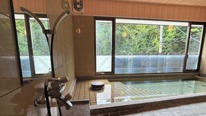 A modern bathroom with a large window, a shower, and a small wooden stool. - Kinosaki Onsen Sanso Ashigaru Ryokan (Toyooka)
