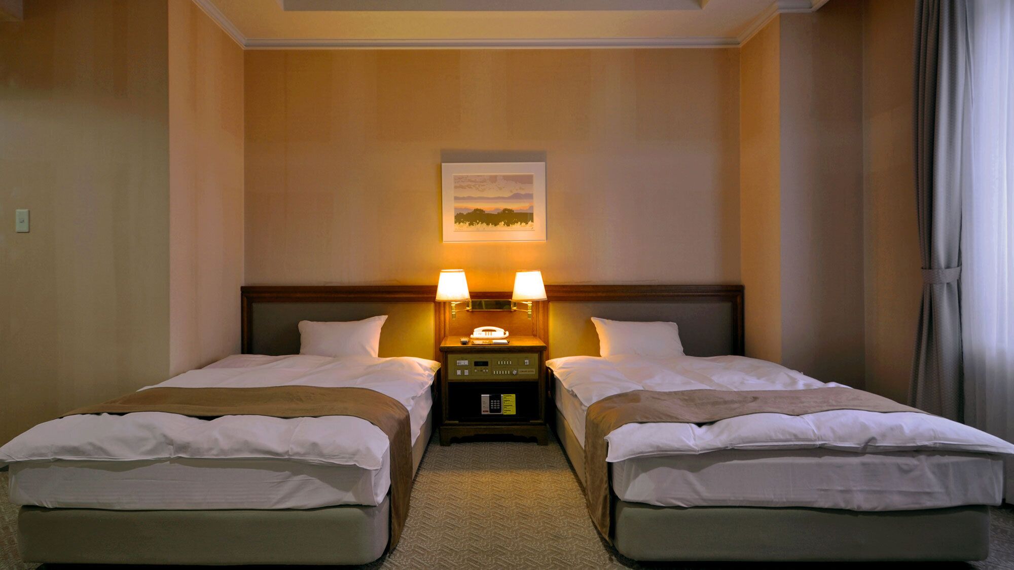 A hotel room with two beds, a nightstand with lamps, a painting on the wall, and a window with curtains.