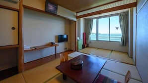 A room with tatami flooring, a television, a small table, and a window with a view. - Amigen (Toba)