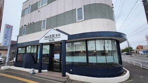 A building with a sign reading 'Go-Ro' and a Coca-Cola sign on the left. - Hotel Goro Hakodate (Hakodate)