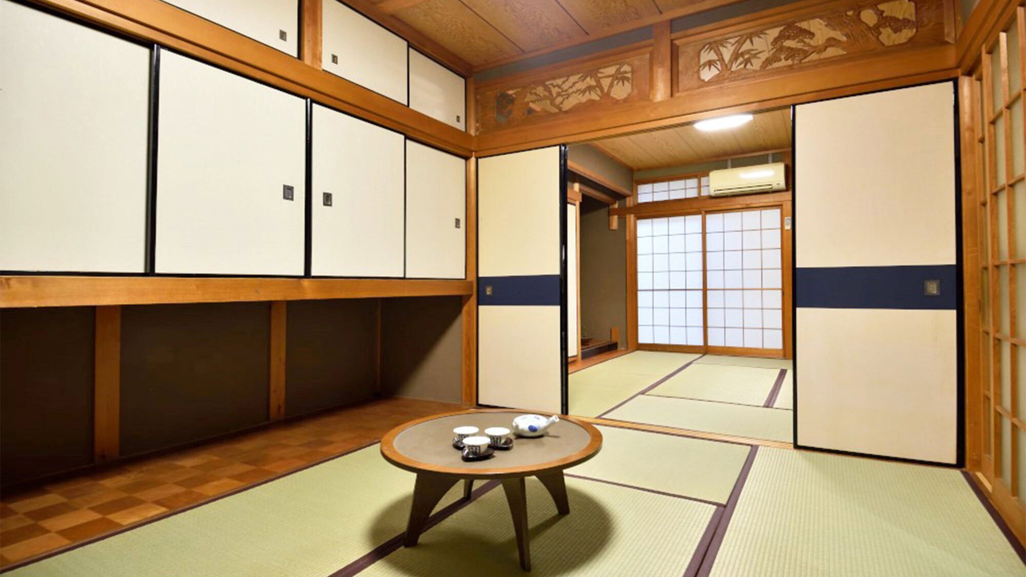 Une pièce de style japonais traditionnel, avec un sol recouvert de tatamis, des paravents shoji et une petite table sur laquelle est disposé un service à thé.