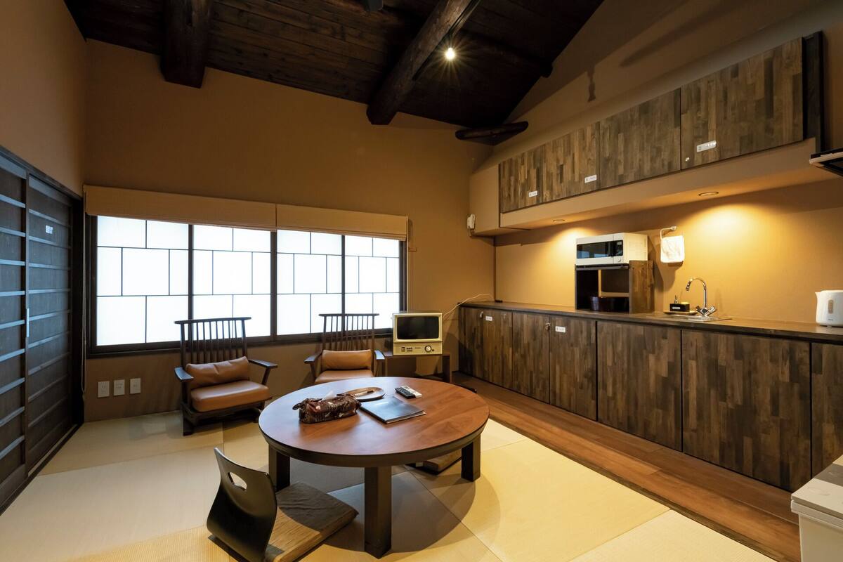 A modern kitchen with wooden cabinets, a microwave, and a sink.