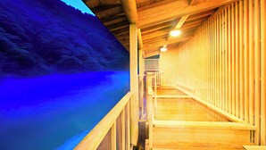 A wooden interior with a wooden staircase leading to a higher level.