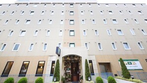 A multi-story hotel with a symmetrical facade, a central entrance, and a sign indicating a restaurant on the ground floor. - Washington R&B Hotel Sendai Hirose-dori Station (Sendai)