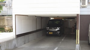 A parking garage with a vehicle inside. - Nozawa Onsen Yamaya Sanso (Nozawaonsen)