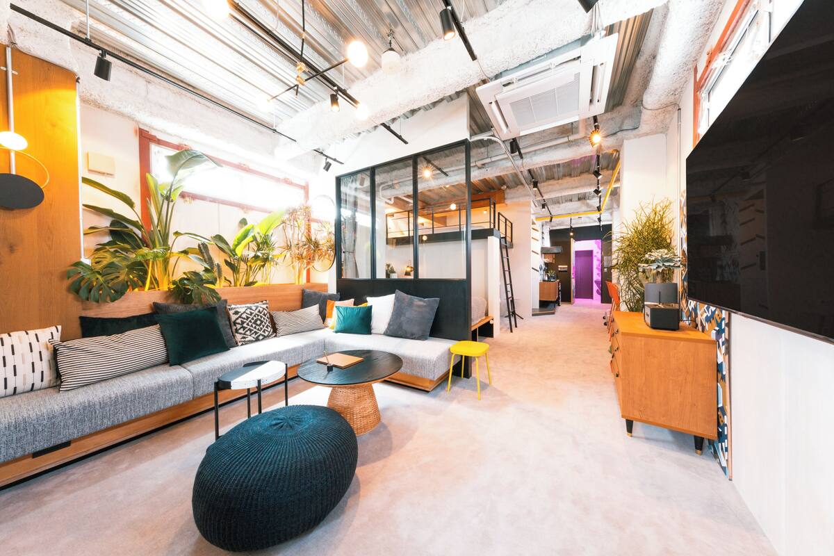 A modern interior with a sofa, round coffee table, and potted plants.