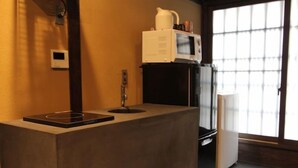 A kitchenette with a microwave, coffee maker, and a small refrigerator. - Kyoto Ryoan Zen (Kyoto)