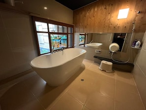 A modern bathroom with a freestanding bathtub, a sink, and a shower. - Takeya Kitano Honkan (Kyoto)
