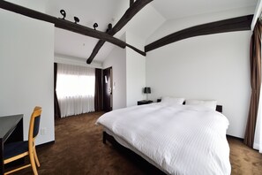 A bedroom with a large bed, a desk, and a chair. - Takeya Kitano Honkan (Kyoto)
