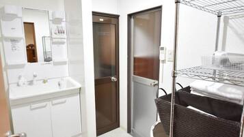 A bathroom with a white sink, mirror, and a towel rack.
