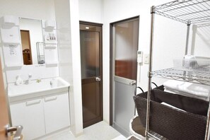 A bathroom with a white sink, mirror, and a towel rack. - Kyo no Yume (Kyoto)