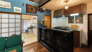 A traditional Japanese-style room with tatami flooring, a low wooden table, and a shoji screen door. - Kyonoyume (Kyoto)