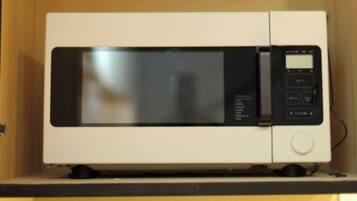 A microwave oven with a digital display and control buttons.