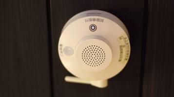 A smoke detector on a wall.