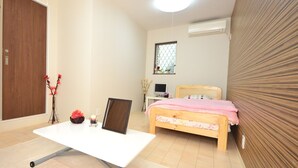 A bedroom with a bed, a desk, a chair, a TV, and a window. - Embellir (Ibaraki)