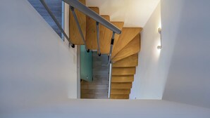 A modern staircase with wooden steps and metal handrails. -  1 bedroom apt in Korčula -Cozy Island Retreat /Walk Everywhere+Private Parking/ (Korčula)