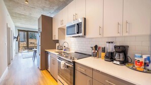 A modern kitchen with stainless steel appliances, a microwave, and a coffee maker.