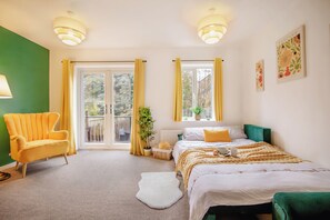 A bedroom with a bed, a chair, a window, and a door. - Central Cactus Luxurious Home | Free Parking 10PPL (Sheffield)