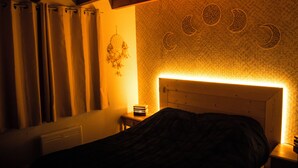 A bedroom with a bed, curtains, a wall clock, and a headboard with a light. - Le P'tit Chalet, at 1000m altitude (Campan)