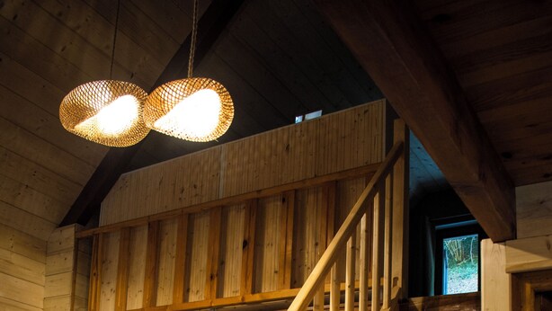 A wooden interior with a staircase, wooden furniture, and a hanging light fixture. - Le P'tit Chalet, at 1000m altitude (Campan)