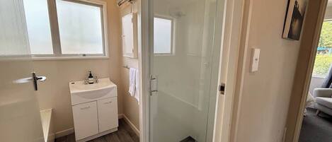 Shower, hair dryer, towels, shampoo