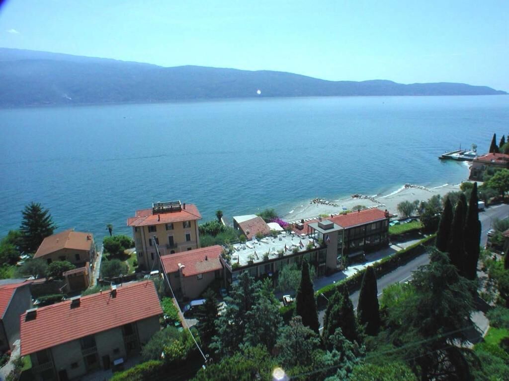A coastal town with buildings, a beach, and a view of the sea.