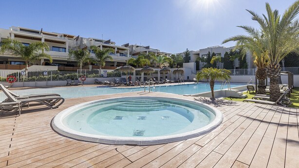 A pool area with lounge chairs, a hot tub, and palm trees. - Luxury 3 Bed Terraced Apt Near La Cala Beach (La Cala de Mijas)