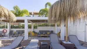 An outdoor lounge area with sun loungers, a sofa, and a covered seating area. - Luxury 3 Bed Terraced Apt Near La Cala Beach (La Cala de Mijas)