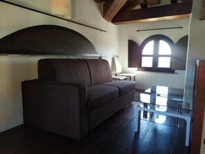 Suite junior, vista al mar | Área de sala de estar