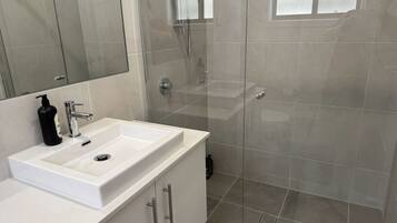 Shower, hair dryer, towels, toilet paper